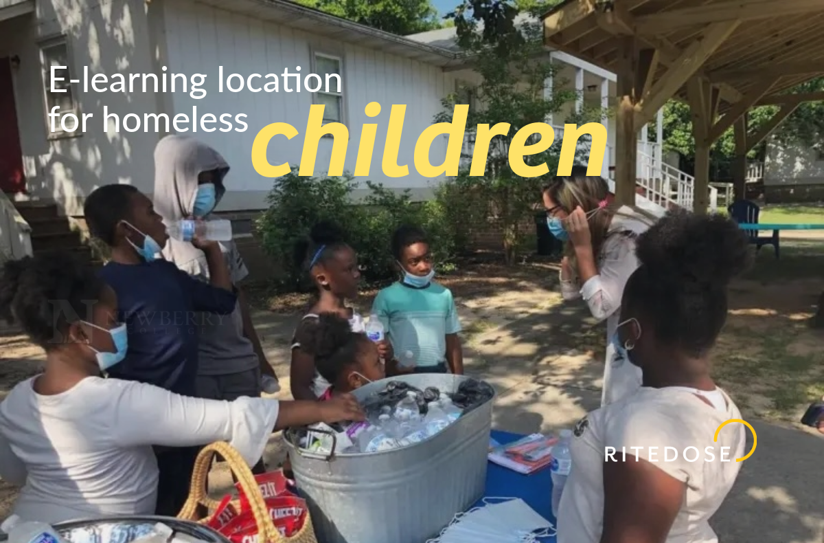 group of children standing under a pavilion with text overlay: e-learning location for homeless children