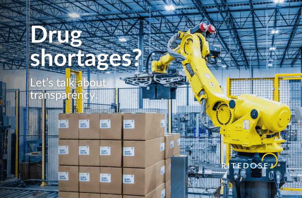 Automated pharmaceutical warehouse with a yellow robotic arm stacking cardboard boxes, illustrating Ritedose’s focus on transparency, efficiency, and solutions for drug shortages.